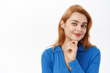 Close up portrait of smiling woman, young professional, hold hand on chin and looking confident and happy at camera, standing over white background