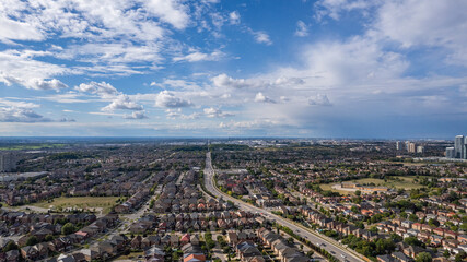 Drone shot of a cityscape view under blue cloudy sky