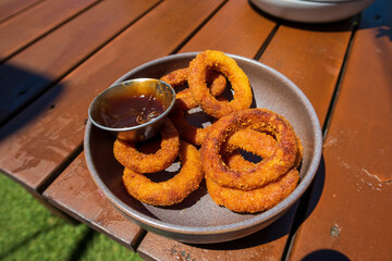 Close-up of onion rings in plate on the table