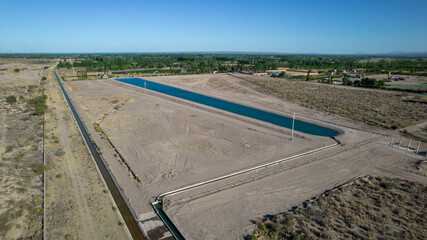 Aerial view of artificial water reservoir for agricultural irrigation.
