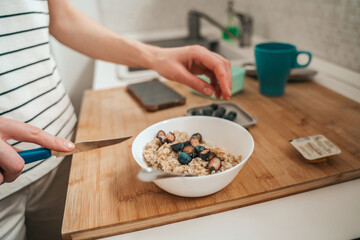 Woman preparing healthy breakfast in the kitchen