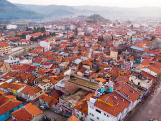 Fototapeta na wymiar Aerial view of Burdur cityscape with similar brownish tiled roofs on residential buildings in winter day, Turkey