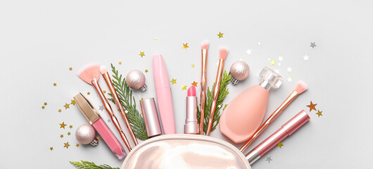 Christmas composition with bag and makeup cosmetics on light background