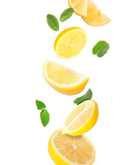 Fresh flying lemon slices and mint leaves isolated on white