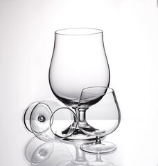 Glass wine glasses for wine and cognac on a white background