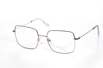glasses with diopters in a thin gold frame on a white background