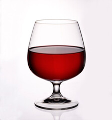 Glass goblet with red wine on white background