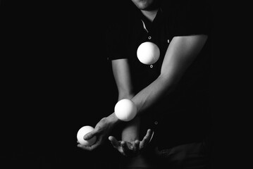 close up portrait of juggling balls, on black background