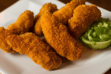 picture of chicken tenders, made of processed meat, a tasty fast food, savory