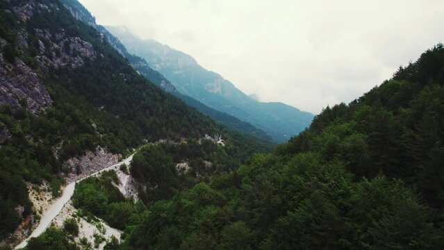 Holidays in Greece. Hiking and trekking concept. Aerial perspective of Mount Olympus covered with Bosnian pine forests. Cloudy sky. High quality 4k footage