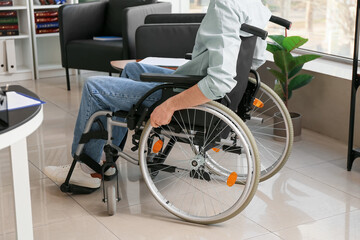 Young man in wheelchair  at home