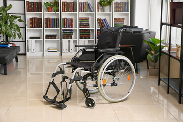 Modern empty wheelchair in home library