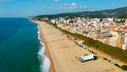 Fototapeta na wymiar Aerial view from drone of Calella Beach on sunny autumn day in Catalonia, Spain