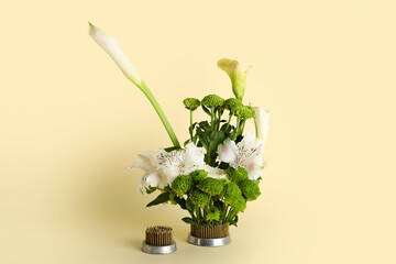 Kenzan with beautiful ikebana on beige background