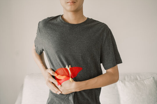 Young man with liver pain, hepatitis vaccination, liver cancer treatment, world hepatitis day
