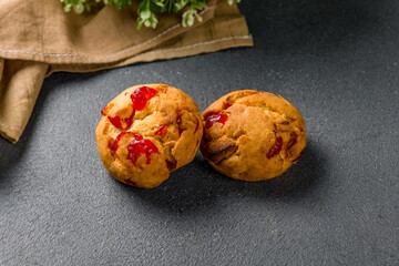 cherry cookies on grey concrete table side view