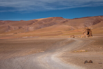 Fototapeta na wymiar Dirt road in Atacama desert, volcanic arid landscape in Chile, South America