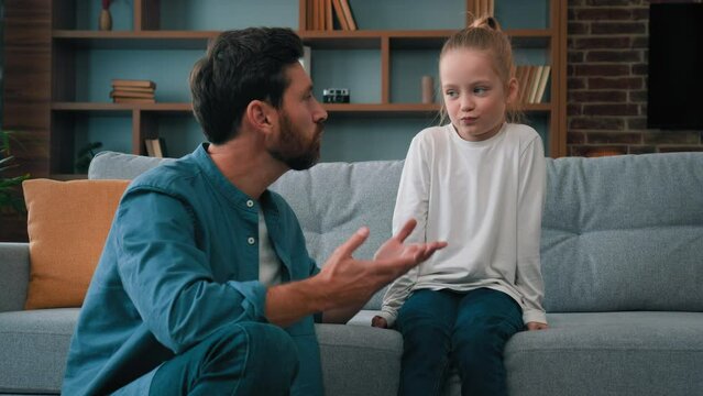 Caring father caucasian man dad trying to contact with offended child girl helping little kid daughter talking sincerely about misunderstanding problem mistrust between children and parents in family