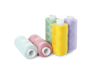 Many different colorful sewing threads on white background