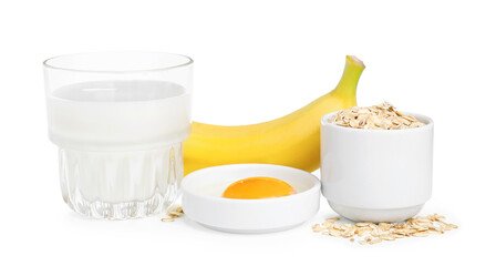 Tasty oatmeal pancakes and ingredients on white background