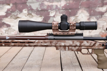 Modern powerful sniper rifle with telescopic sight outdoors