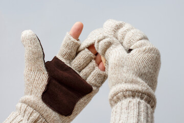 Gloved hands cover the top, protecting fingers from the cold. Selective focus.