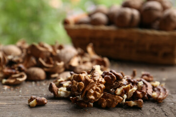 Obraz premium Pile of shelled walnuts on wooden table against blurred background, closeup. Space for text