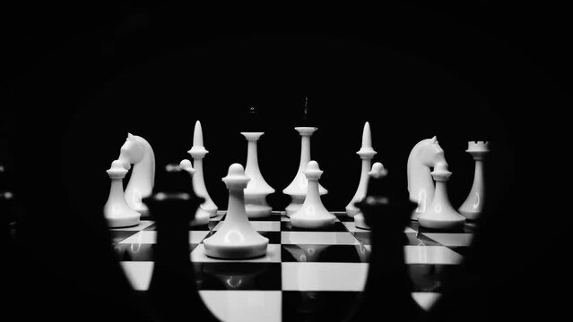 Close-up of a chess match where both sides move their pawns across the board