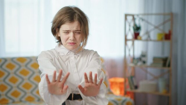 Schoolgirl makes vomiting gesture showing disagreement