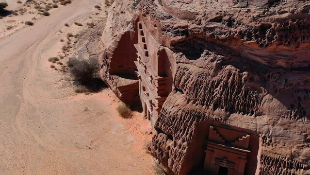 Tomb at Al-Hijr, Hegra, Madain Salih Archaeological Site in sunny Saudi Arabia - circling, aerial view
