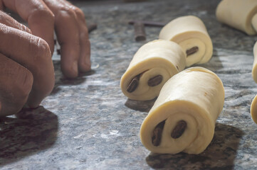 Baker making pain au chocolat before going to the oven,bakery concept with coppy space
