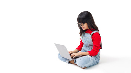 A young girl enjoyed to play a social network on laptop computer