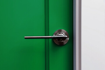 Close-up of green door with modern handle