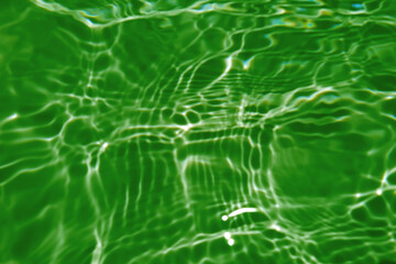 Defocus blurred transparent blue colored clear calm water surface texture with splash, bubble. Shining blue water ripple background. Surface of water in swimming pool. Blue bubble water shining.