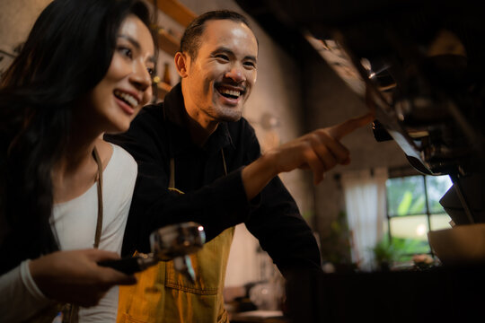 Barista Training Staff Using Coffee Matchine In Coffee Shop Cafe