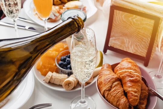 Pouring prosecco or champagne into a glass close-up.