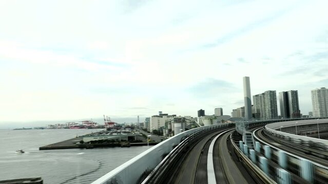 Tokyo,Japan - October 9, 2022: (3x speed) The Tokyo Waterfront New Transit Waterfront Line running on the loop to cross Rainbow bridge
