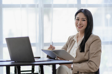 Asian businesswoman using laptop Communicate over the Internet with customers at home. online work...
