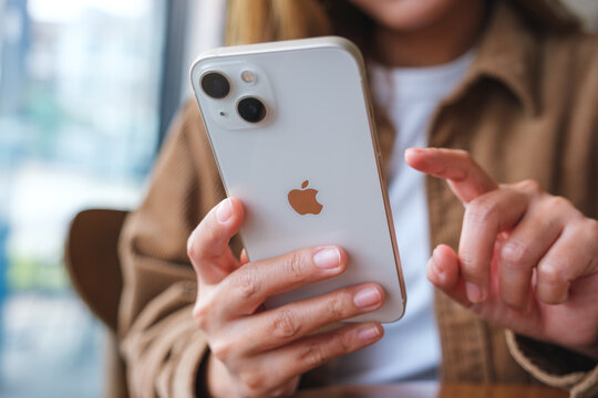 Oct 6th 2022 : A woman holding and touching on Iphone 13 smart phone screen, Chiang mai Thailand