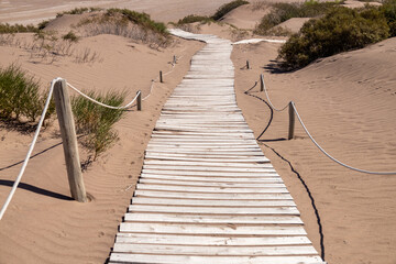 Winding path of wooden boards to the beach.