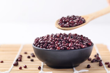 Azuki beans, Adzuki bean or red mung beans in black bowl with spoon, Food ingredients in many Chinese dishes and filling in Japanese sweet
