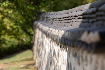 Stone wall of a Korean traditional house. warm sunshine