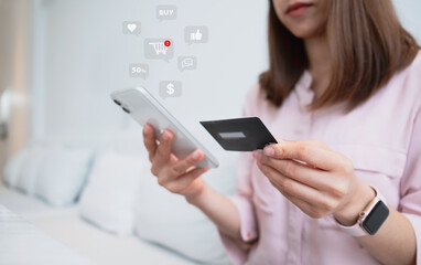 Woman hand holding credit card and smartphone for paying online using banking service. Online shopping concept