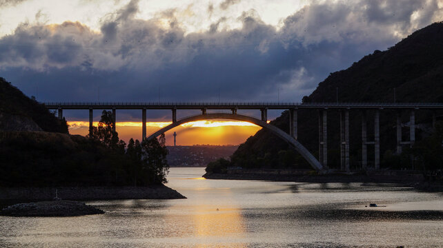 Sunset landscape from the San Roque dam, looking to a large bridge and the last minutes of  sunlight in Villa Carlos Paz , Cordoba 
