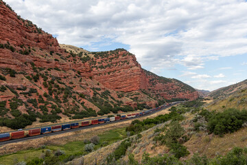 Fototapeta na wymiar Freight train through the canyon 