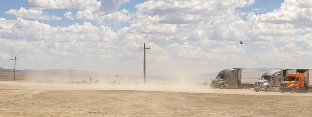 trucks during a sandstorm in the desert