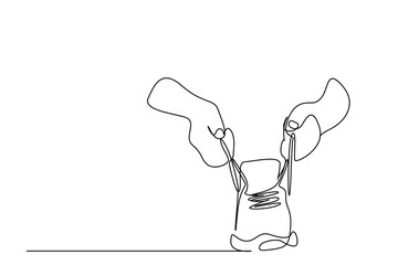 hands of a person tying the laces of sneakers