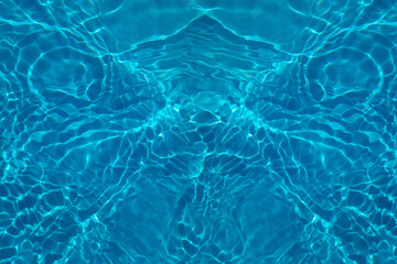 Defocus blurred transparent blue colored clear calm water surface texture with splash, bubble. Shining blue water ripple background. Surface of water in swimming pool. Blue bubble water shining.