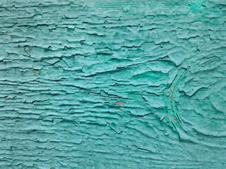 Texture of old cracked turquoiseturquoiseturquoise paint paint on the wooden surface. Background, close-up