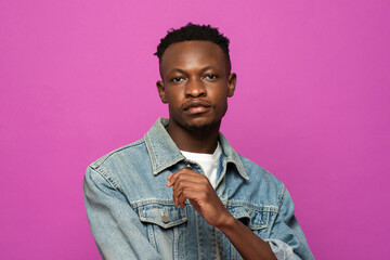 Portrait of young handsome African man model posing in purple color studio isolated background